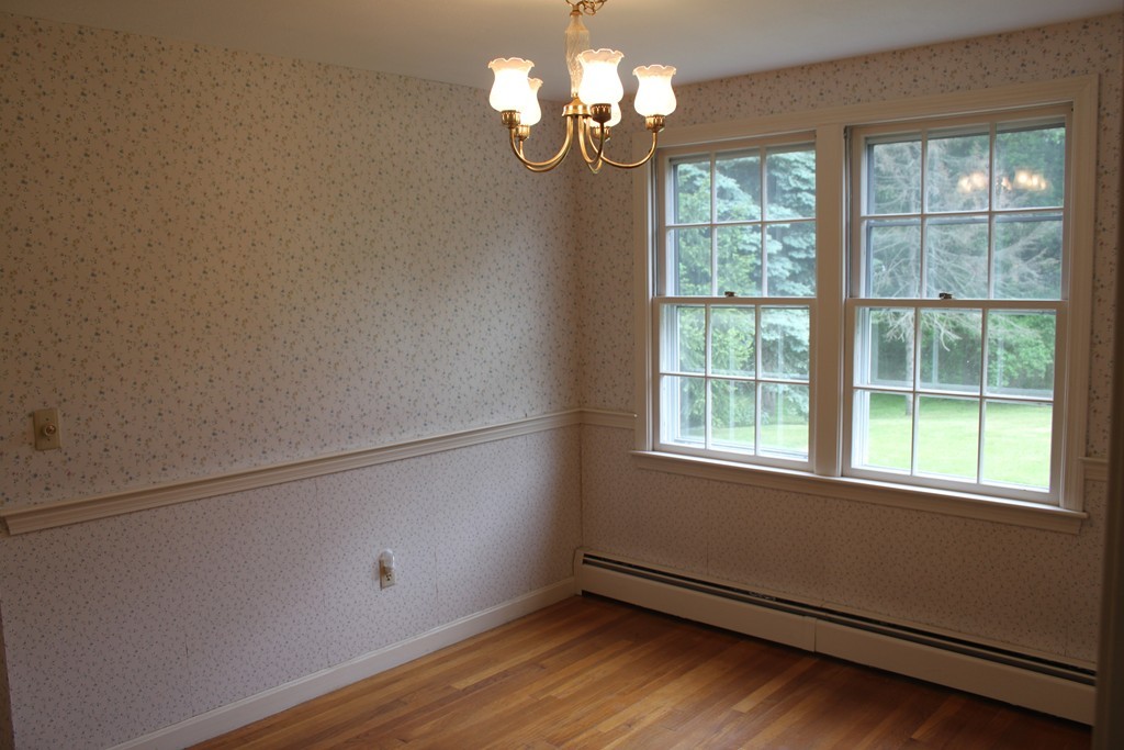 13 Haverhill Road Topsfield, MA 01983 - Photo 8 of 20 a view of wooden floor and chandelier fan in a room
