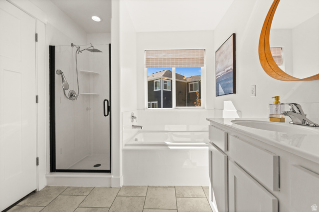 14728 South Canyon Pointe Road Draper, UT 84020 - Photo 18 of 35 Contemporary bathroom with a built-in tub, separate shower with a black-framed glass enclosure, and a vanity featuring an integrated sink