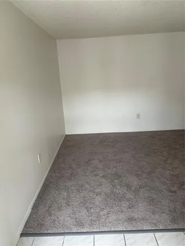 a kitchen with a sink a refrigerator and cabinets