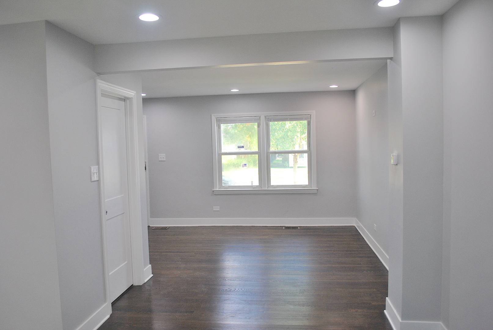 10052 South Green Street Chicago, IL 60643 - Photo 6 of 22 an empty room with wooden floor and windows