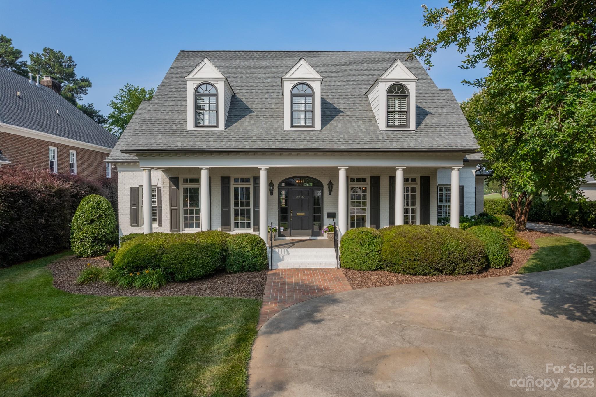 2810 Sharon Road Charlotte, NC 28211 - Photo 1 of 37 a front view of a house with garden