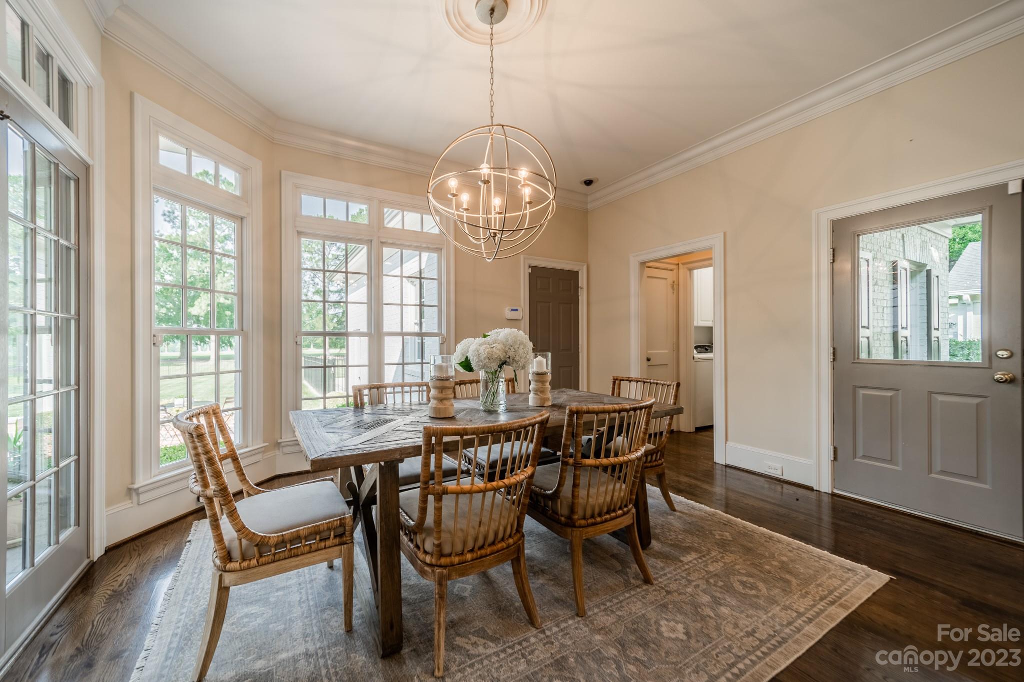 2810 Sharon Road Charlotte, NC 28211 - Photo 11 of 37 a dining room with furniture a chandelier and wooden floor