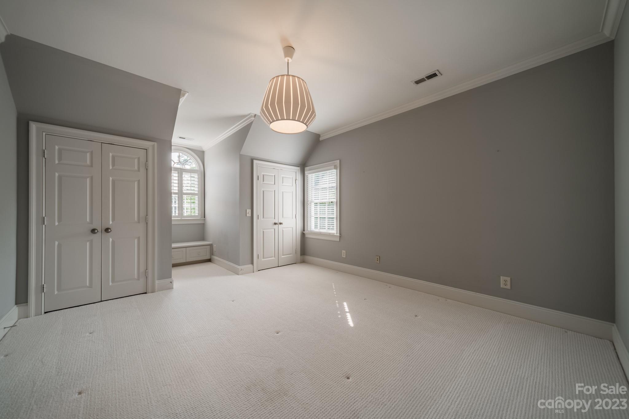 2810 Sharon Road Charlotte, NC 28211 - Photo 26 of 37 a view of empty room with a chandelier fan and window