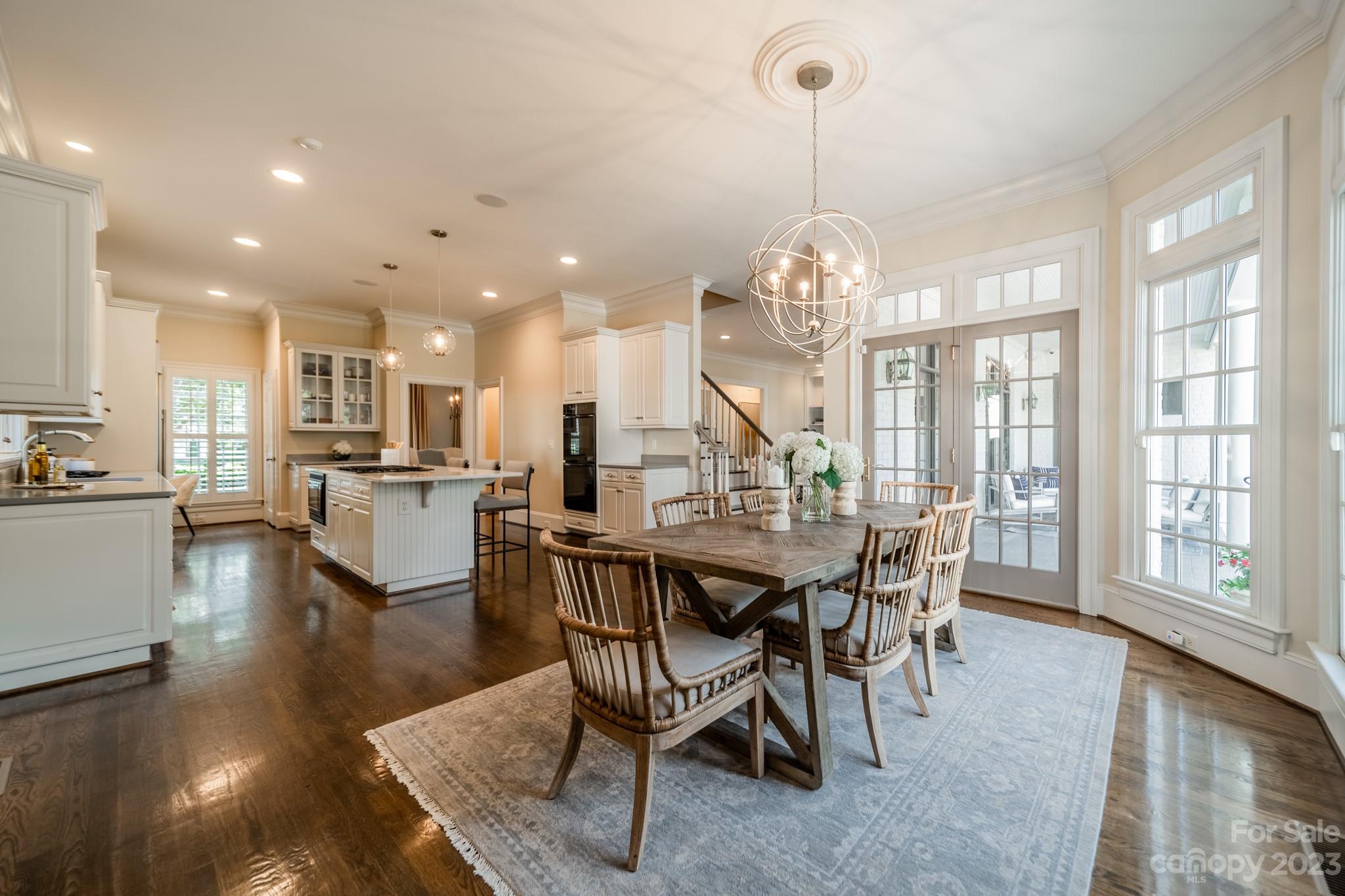 2810 Sharon Road Charlotte, NC 28211 - Photo 8 of 37 a view of a dining room with furniture wooden floor and chandelier