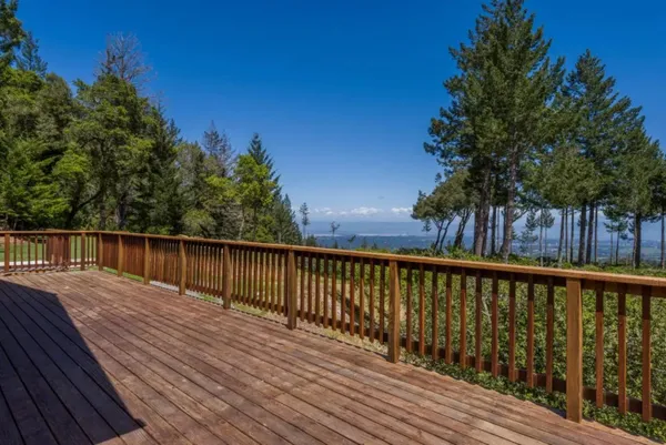 a balcony with wooden floor and fence