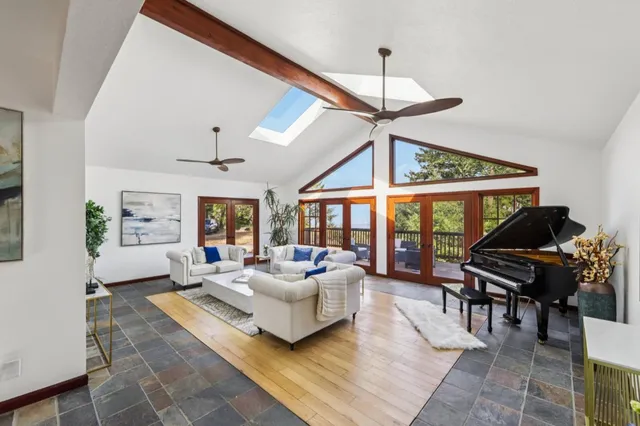 a living room with furniture a dining table and a piano