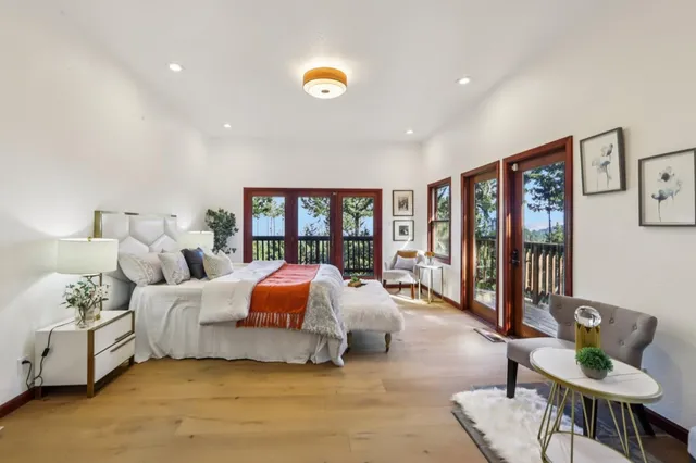 a bedroom with bed and glass window