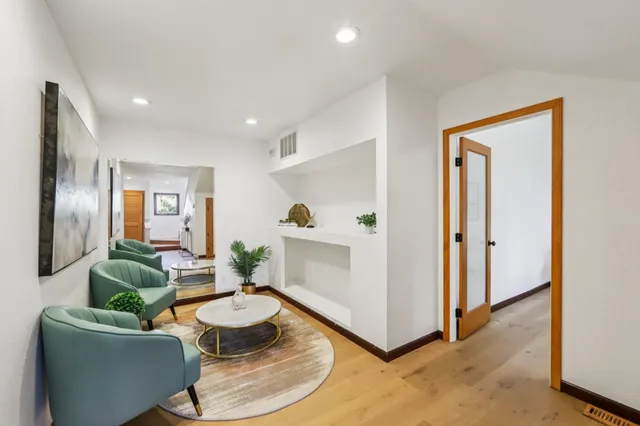 a living room with furniture and wooden floor