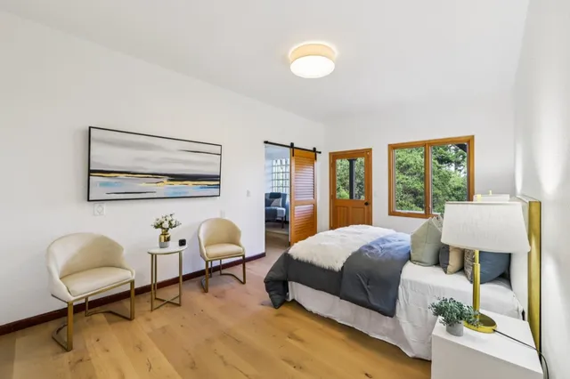 a bedroom with furniture and a window