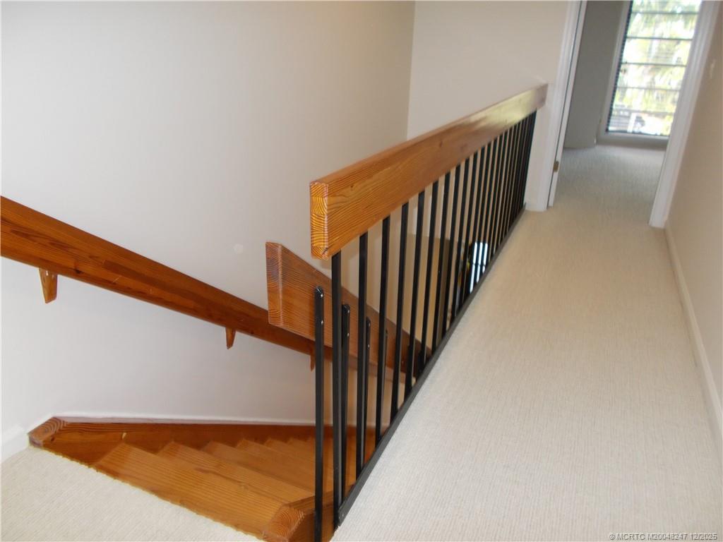 4761 Southeast Binnacle Way, Unit 108 Stuart, FL 34997 - Photo 15 of 43 a view of staircase with railing and white walls