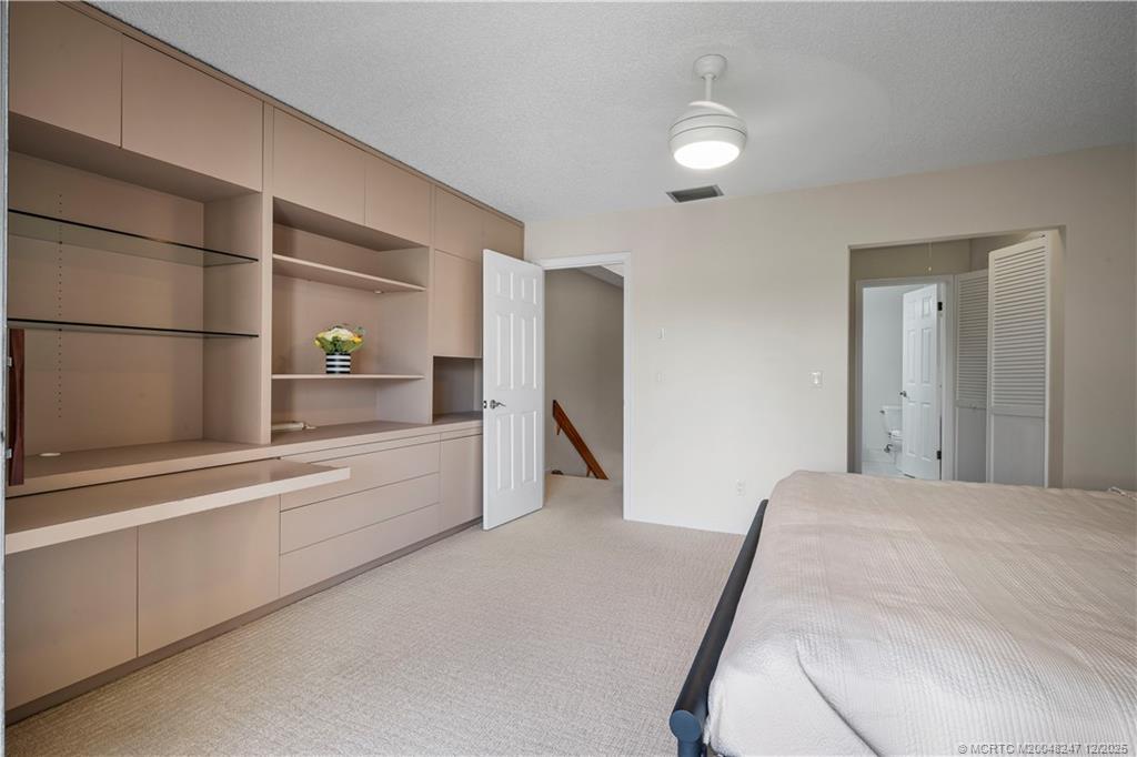 4761 Southeast Binnacle Way, Unit 108 Stuart, FL 34997 - Photo 16 of 43 Master bedroom hidden office & storage