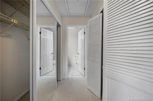 an aerial view of a residential houses with outdoor space and trees