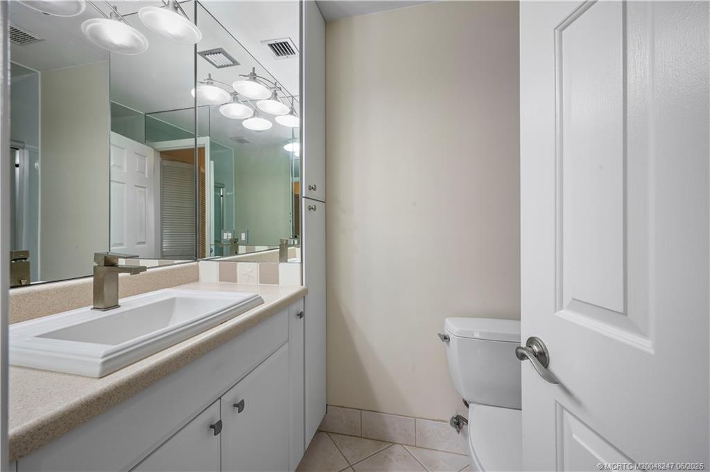 4761 Southeast Binnacle Way, Unit 108 Stuart, FL 34997 - Photo 18 of 43 a bathroom with a sink and a mirror