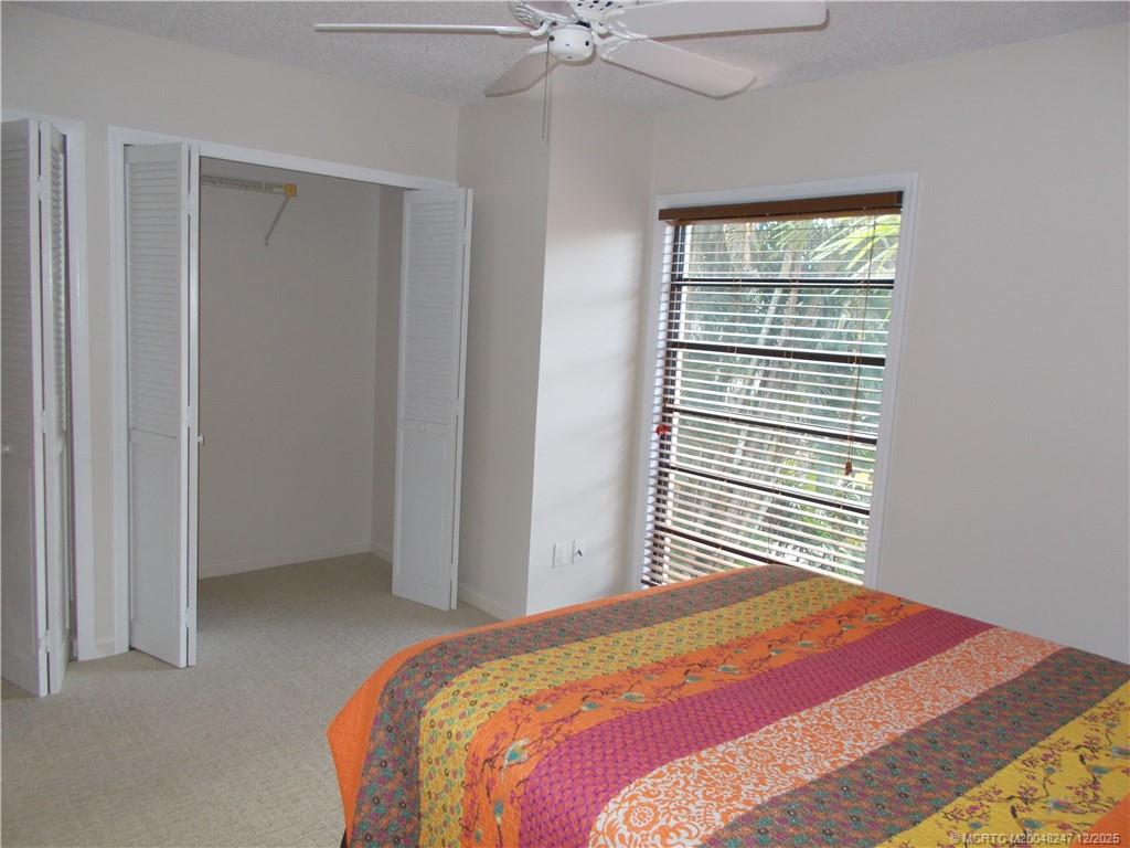4761 Southeast Binnacle Way, Unit 108 Stuart, FL 34997 - Photo 23 of 43 a bedroom with a bed and a window