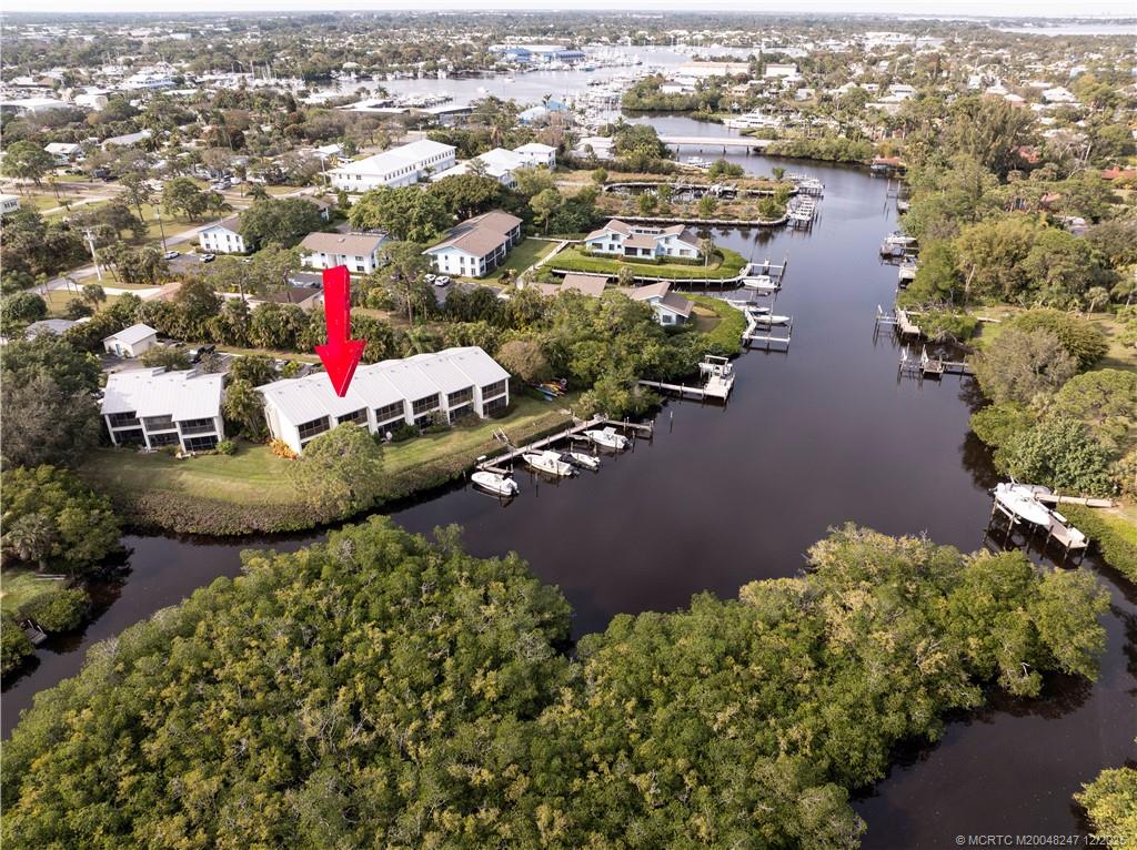 4761 Southeast Binnacle Way, Unit 108 Stuart, FL 34997 - Photo 31 of 43 an aerial view of residential house with outdoor space and lake view