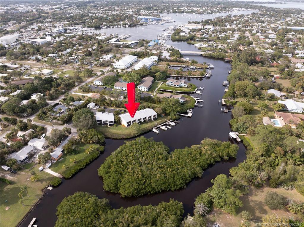 4761 Southeast Binnacle Way, Unit 108 Stuart, FL 34997 - Photo 35 of 43 an aerial view of a house with a yard and lake view in back
