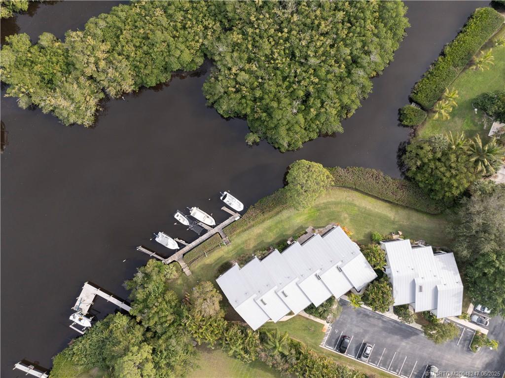 4761 Southeast Binnacle Way, Unit 108 Stuart, FL 34997 - Photo 36 of 43 an aerial view of a house with a yard and lake view