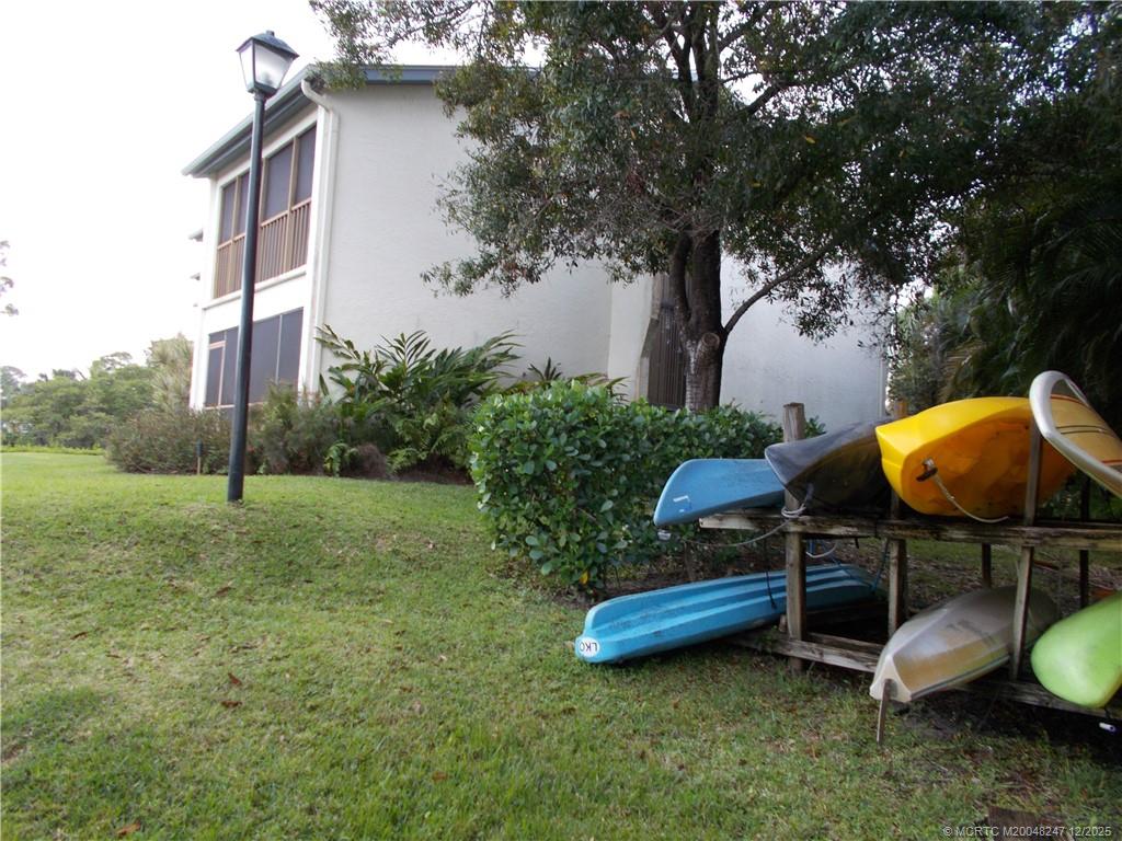 4761 Southeast Binnacle Way, Unit 108 Stuart, FL 34997 - Photo 40 of 43 a view of a backyard with a table and a chairs