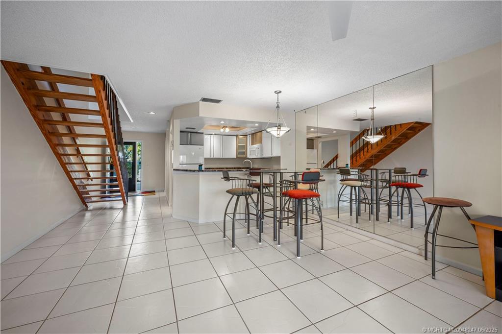 4761 Southeast Binnacle Way, Unit 108 Stuart, FL 34997 - Photo 10 of 43 a room with lots of wooden furniture and a view of living room