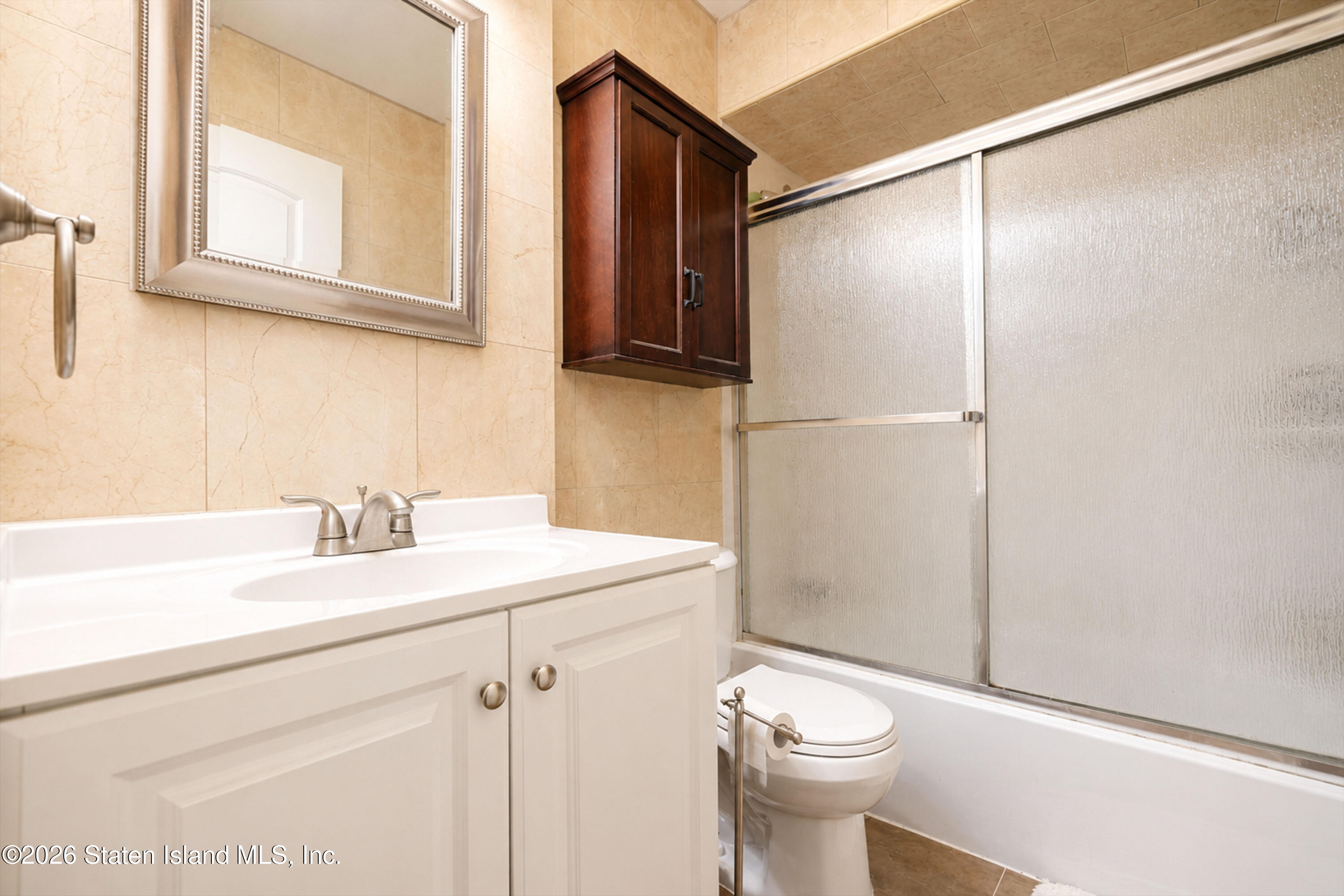 37 Middle Loop Road Staten Island, NY 10308 - Photo 24 of 38 a bathroom with a sink a toilet and shower