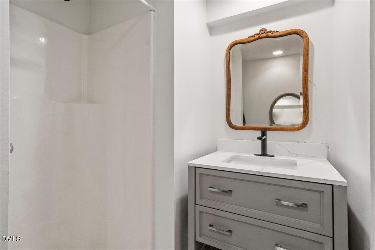 4805 Rembert Drive Raleigh, NC 27612 - Photo 29 of 45 a bathroom with a sink and a mirror