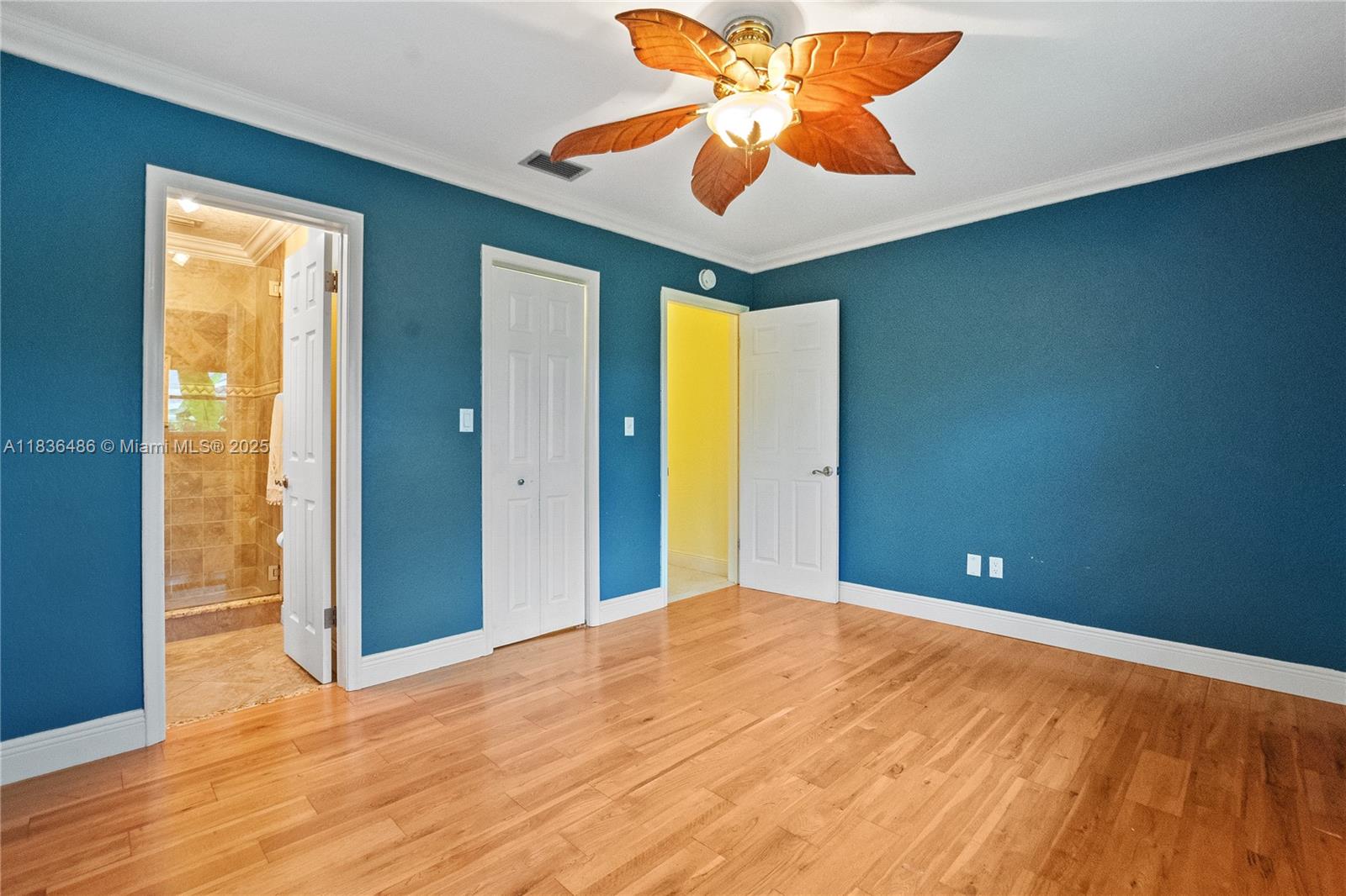 180 Southwest 125th Avenue Plantation, FL 33325 - Photo 15 of 29 a view of a big room with wooden floor and a chandelier fan