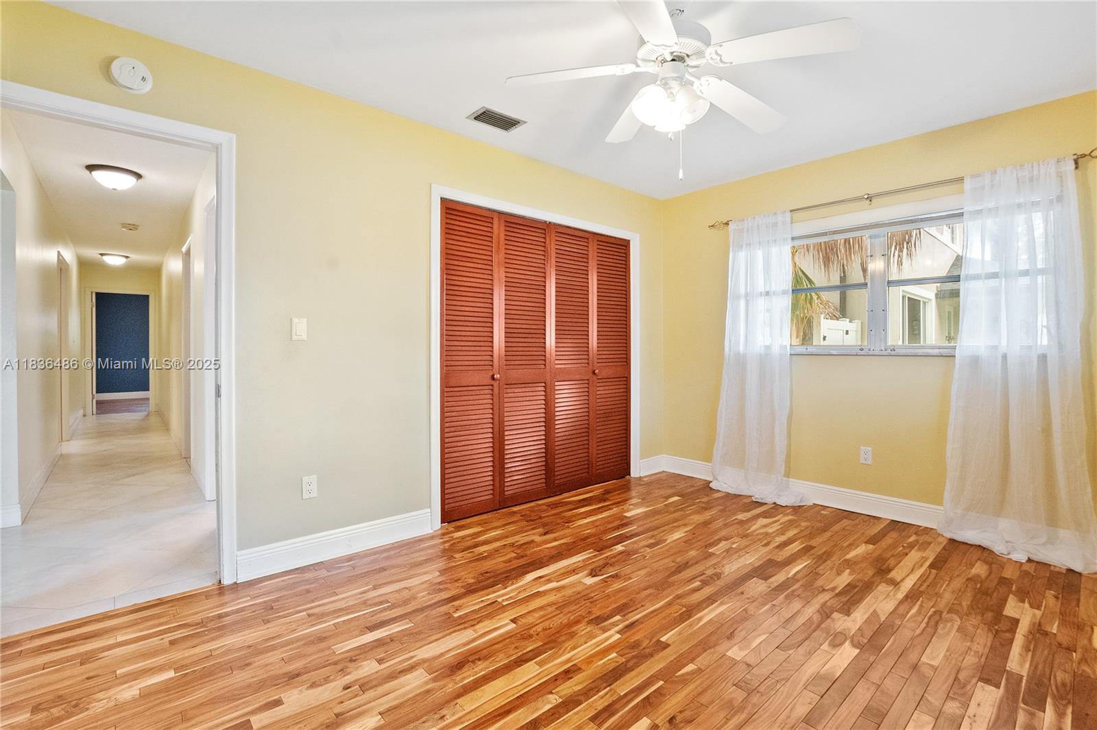 180 Southwest 125th Avenue Plantation, FL 33325 - Photo 17 of 29 wooden floor in an empty room with a window