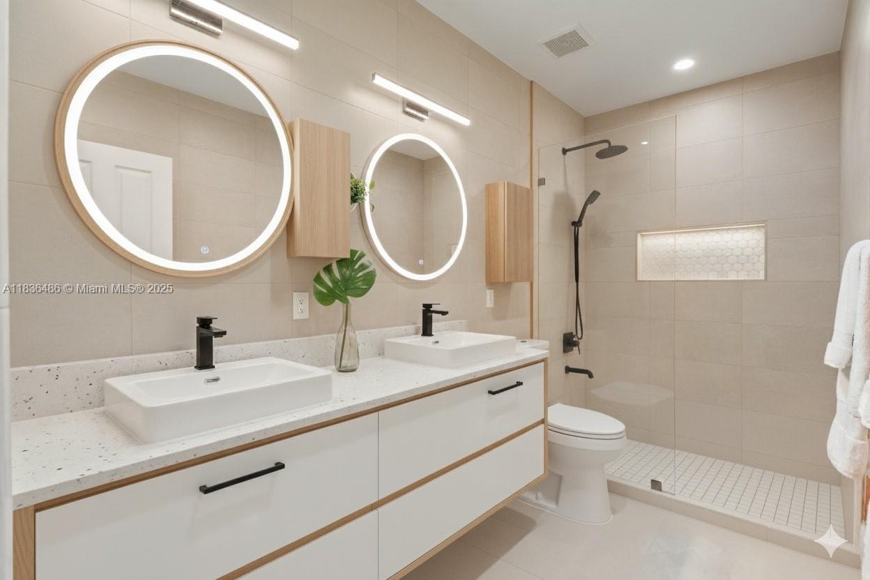 180 Southwest 125th Avenue Plantation, FL 33325 - Photo 18 of 29 a bathroom with a toilet a sink and a mirror