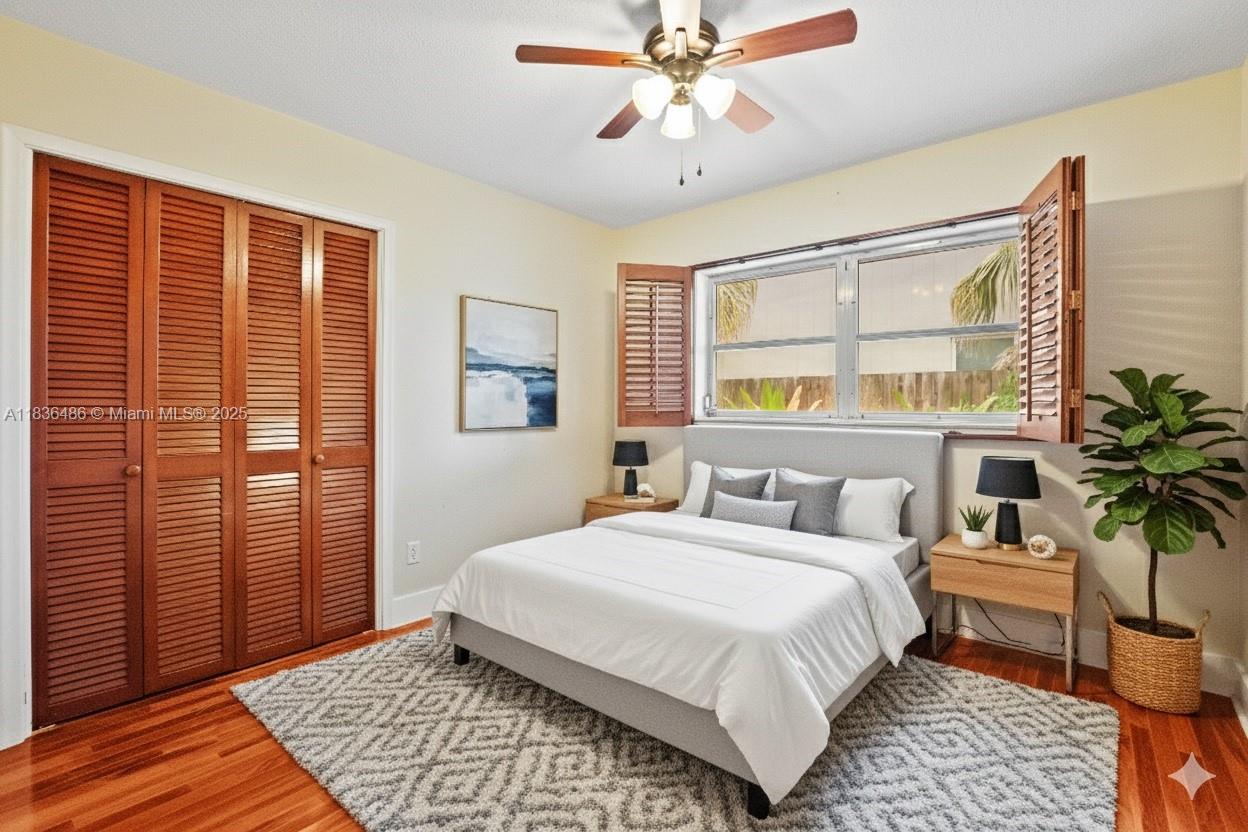 180 Southwest 125th Avenue Plantation, FL 33325 - Photo 21 of 29 a bedroom with a large bed and a chandelier