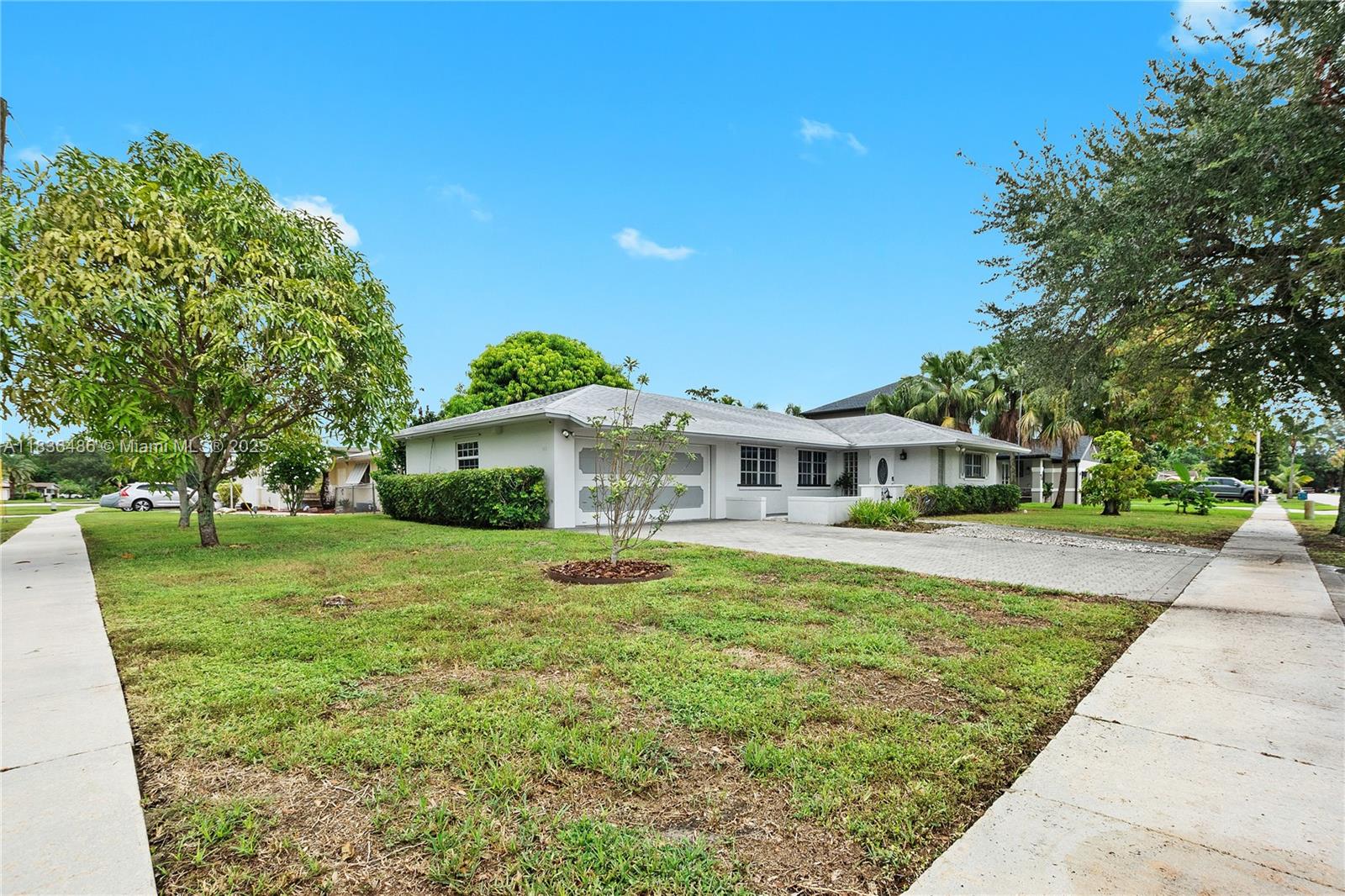 180 Southwest 125th Avenue Plantation, FL 33325 - Photo 25 of 29 a front view of a house with a yard
