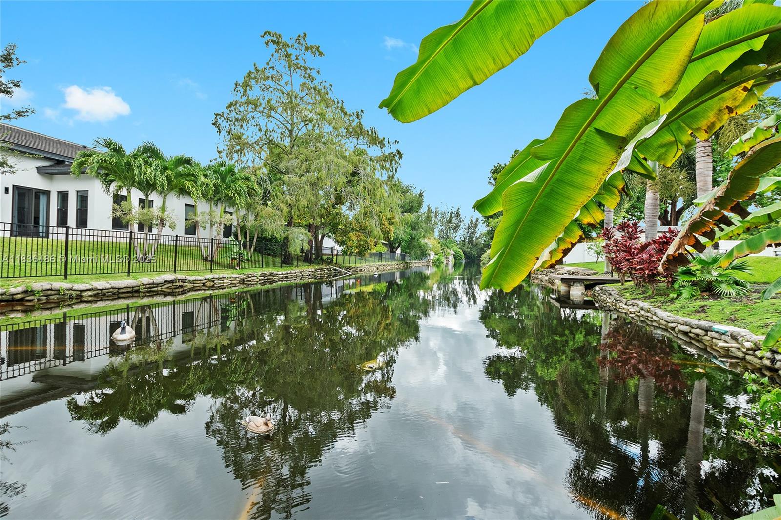 180 Southwest 125th Avenue Plantation, FL 33325 - Photo 29 of 29 a view of a lake with a building in the background