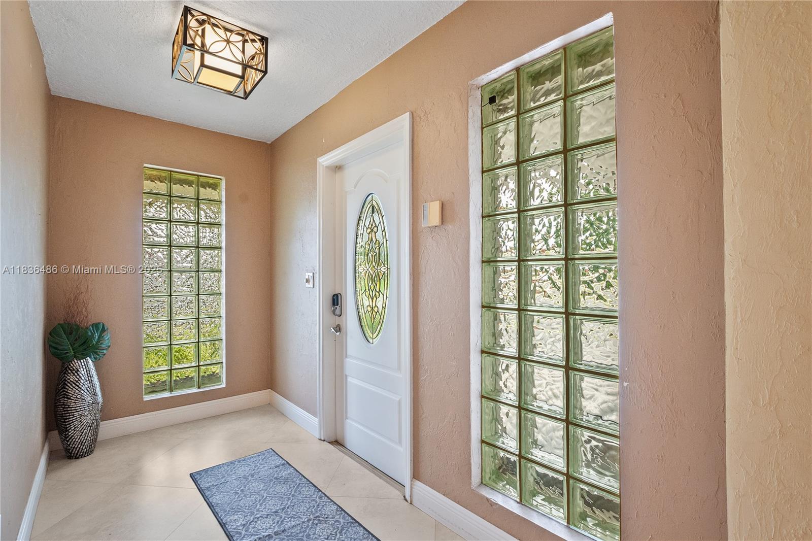 180 Southwest 125th Avenue Plantation, FL 33325 - Photo 6 of 29 a view of an entryway with wooden floor and windows