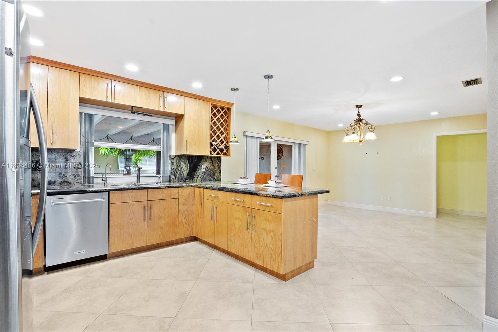 180 Southwest 125th Avenue Plantation, FL 33325 - Photo 9 of 29 a kitchen with stainless steel appliances granite countertop a stove a sink and a refrigerator