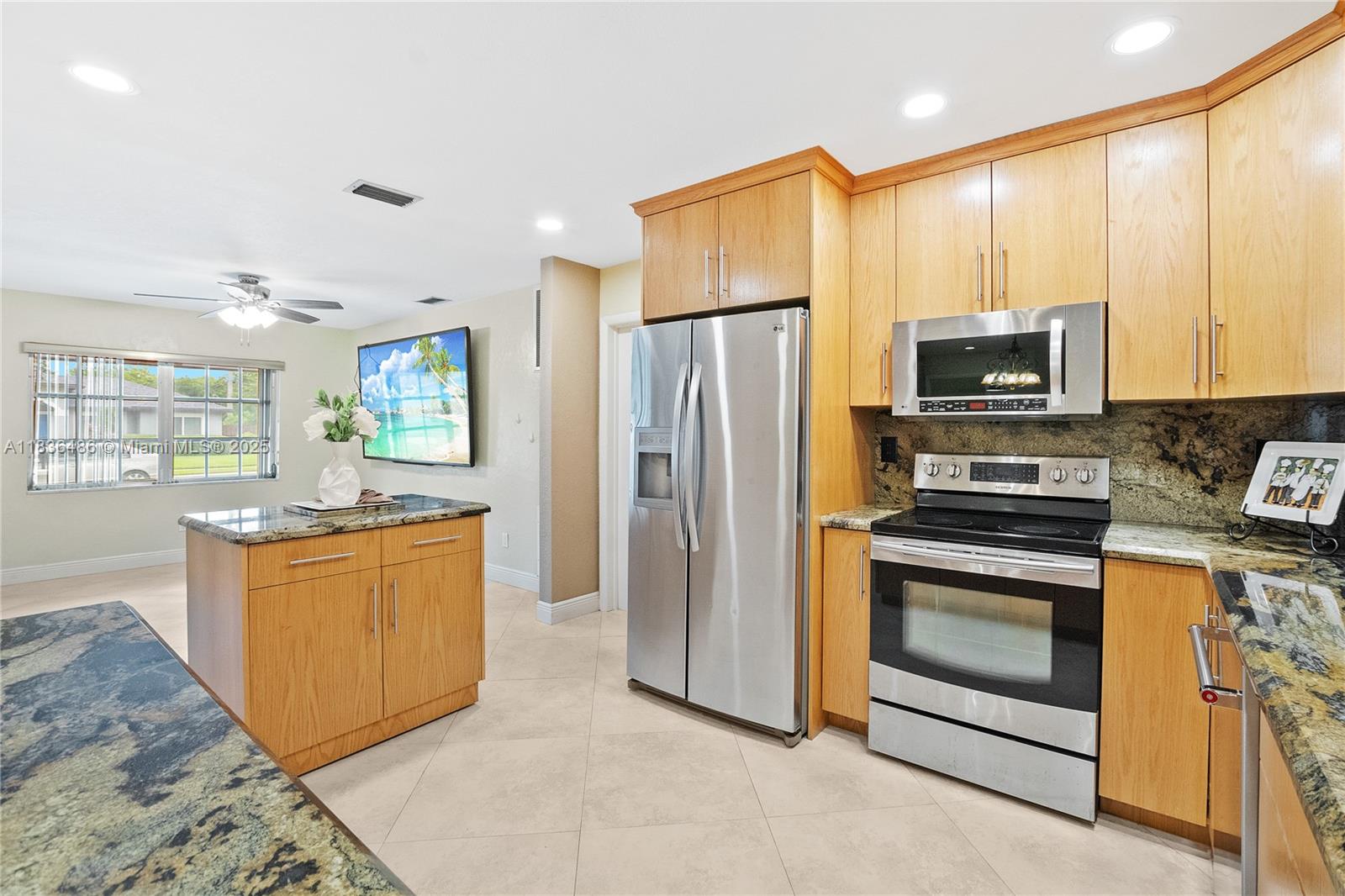 180 Southwest 125th Avenue Plantation, FL 33325 - Photo 10 of 29 a kitchen with stainless steel appliances granite countertop a stove a refrigerator and a stove top oven