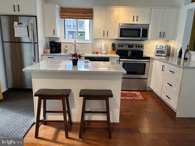 28 Flintlock Lane Chesterbrook, PA 19087 - Photo 15 of 69 a kitchen with stainless steel appliances granite countertop a stove top oven a refrigerator a sink and dishwasher with wooden floor