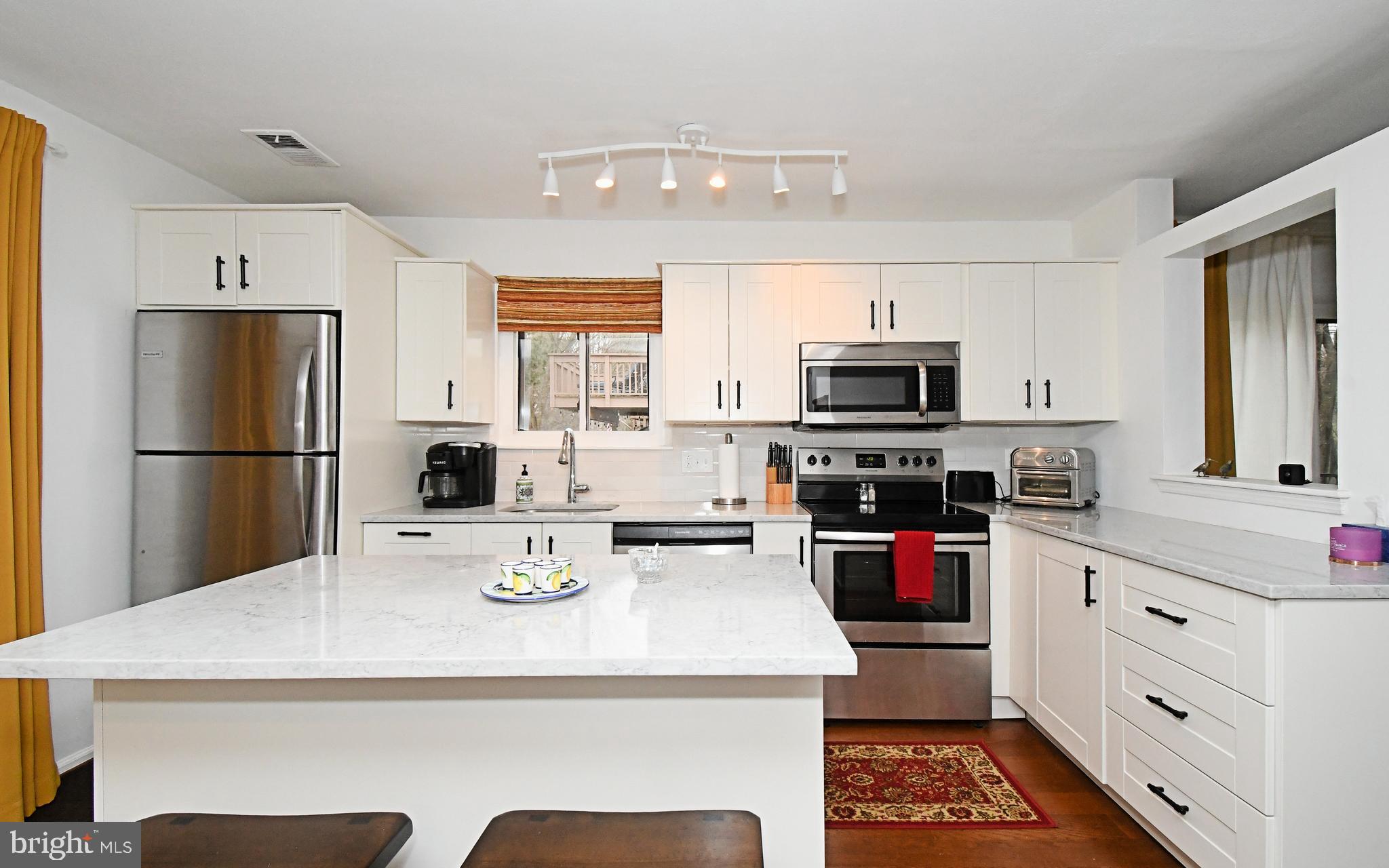 28 Flintlock Lane Chesterbrook, PA 19087 - Photo 41 of 69 a kitchen with a refrigerator a stove a microwave and cabinets