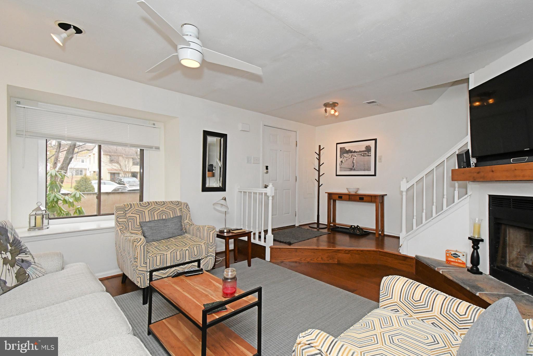 28 Flintlock Lane Chesterbrook, PA 19087 - Photo 9 of 69 a living room with furniture a flat screen tv and a fireplace