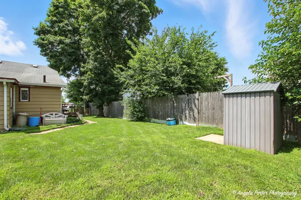 a view of a backyard with a garden and trees