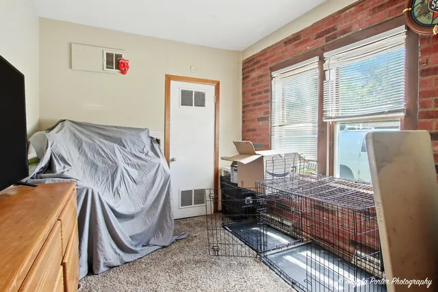 a bedroom with furniture and a window