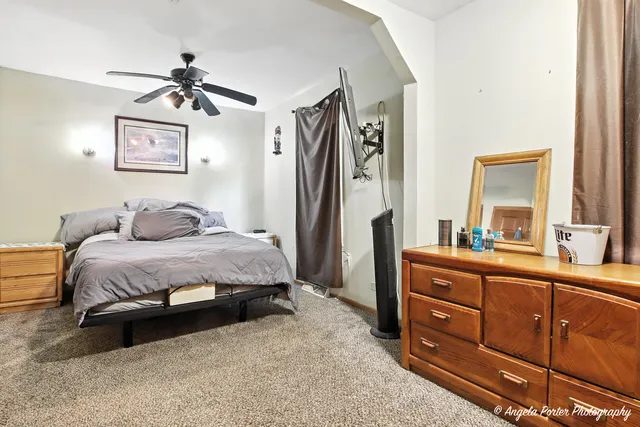 a bedroom with a bed and a dresser