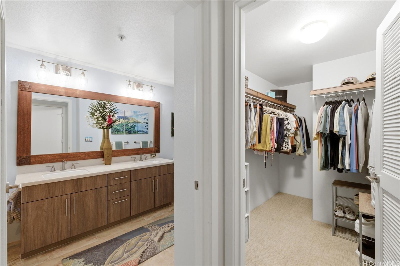 437 Kailua Road, Unit 6108 Kailua, HI 96734 - Photo 13 of 25 Large Primary suite closet. Bathroom with ample storage and custom framing on mirror.