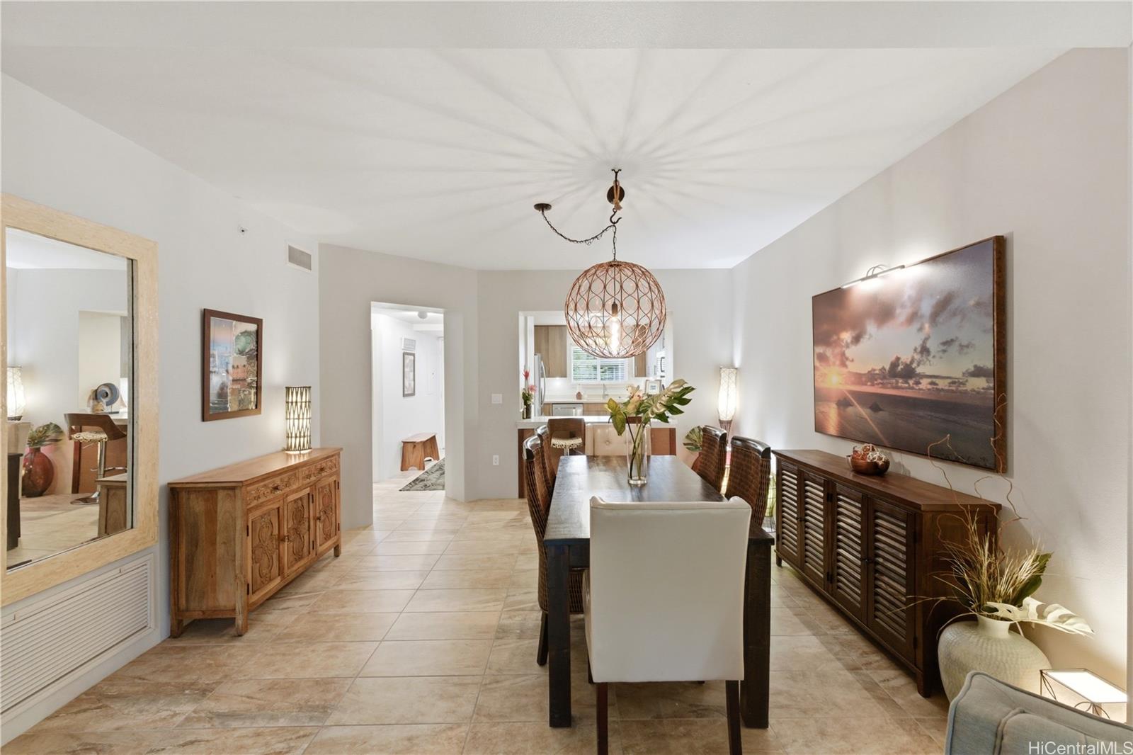 437 Kailua Road, Unit 6108 Kailua, HI 96734 - Photo 3 of 25 The dining area connects seamlessly to the kitchen and breakfast bar, featuring a designer light fixture above the table. Spacious enough for entertaining, cozy enough for family dinners.