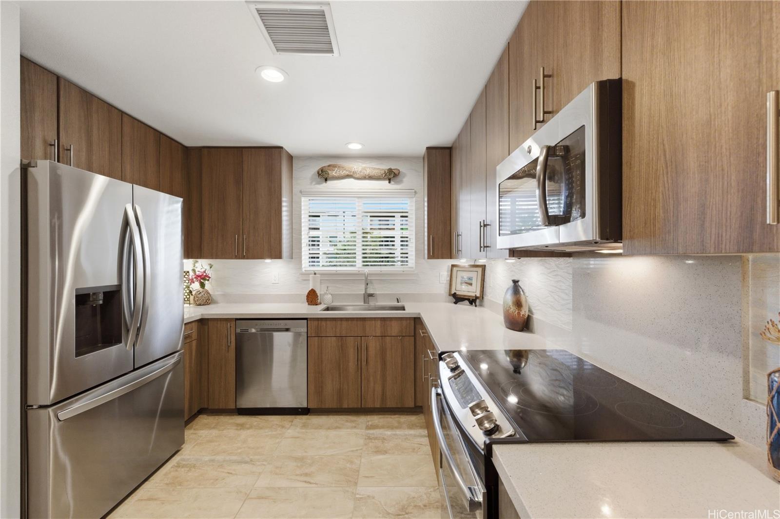 437 Kailua Road, Unit 6108 Kailua, HI 96734 - Photo 5 of 25 Features stainless steel appliances, upgraded soft close cabinetry, and a window above the sink that opens to the outside view.
