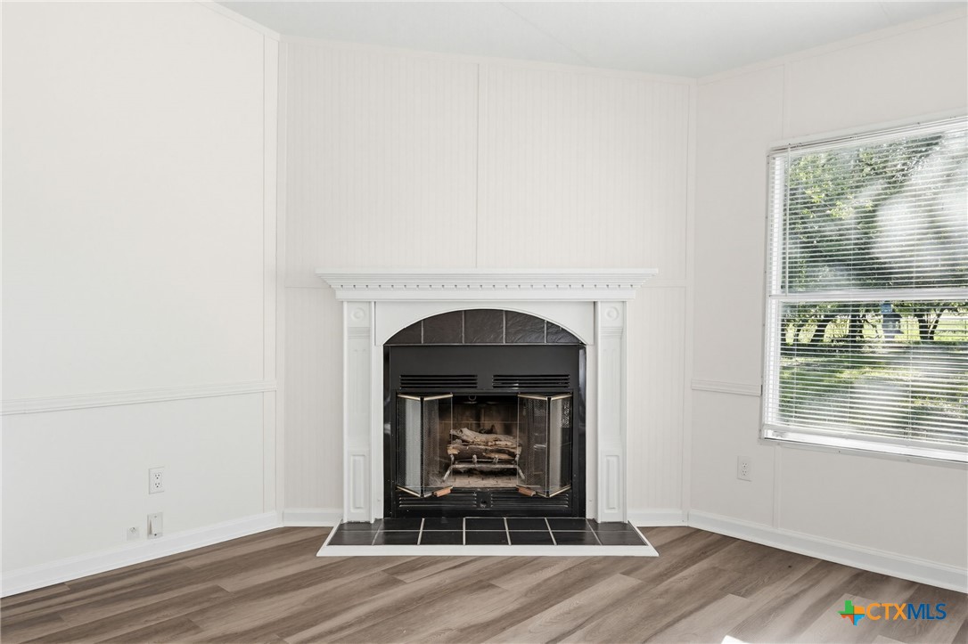 2739 Willow Loop Kempner, TX 76539 - Photo 7 of 30 a living room with a fireplace and a wooden floor