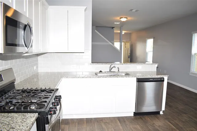 a kitchen with a sink and a stove top oven