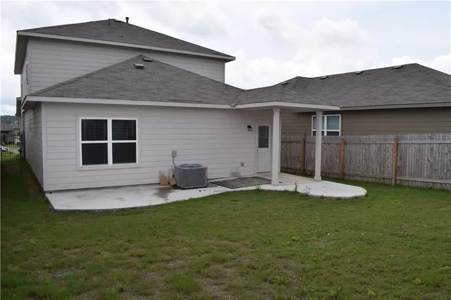 a house that has a big yard with wooden fence