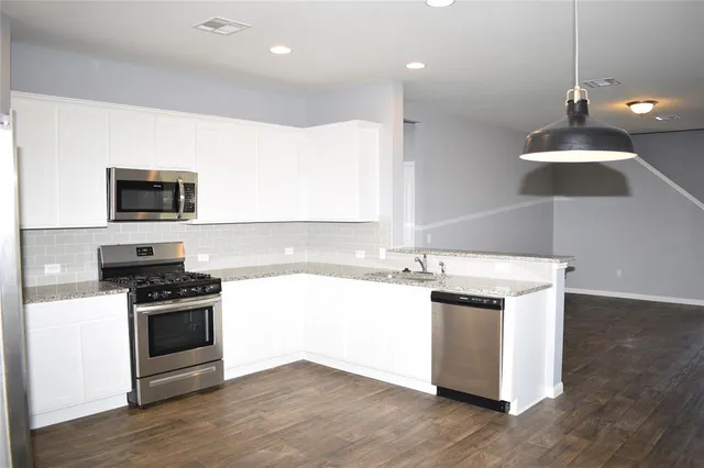 a kitchen with a stove and a sink