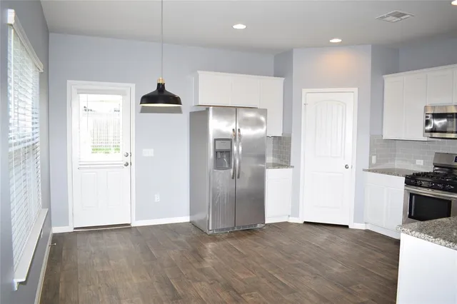 a view of a kitchen with a sink and a refrigerator