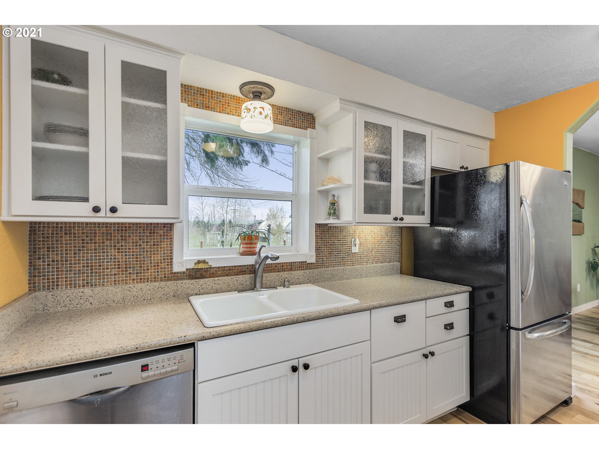 7150 South Barnards Road Canby, OR 97013 - Photo 8 of 32 a kitchen with a sink a refrigerator and cabinets