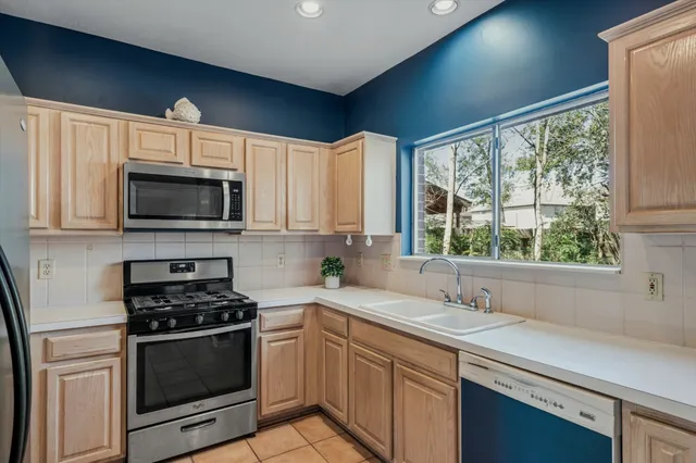 a kitchen with a sink stove and microwave